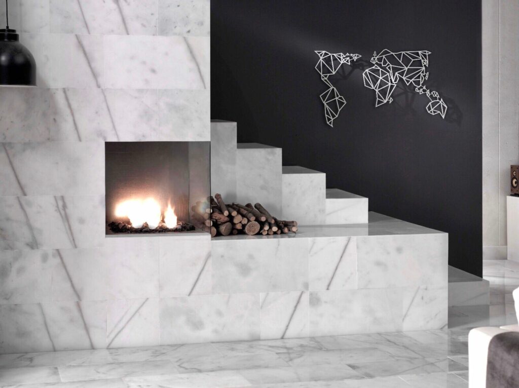 Modern interior featuring a sleek natural stone fireplace surround with white marble design and a contemporary black accent wall.